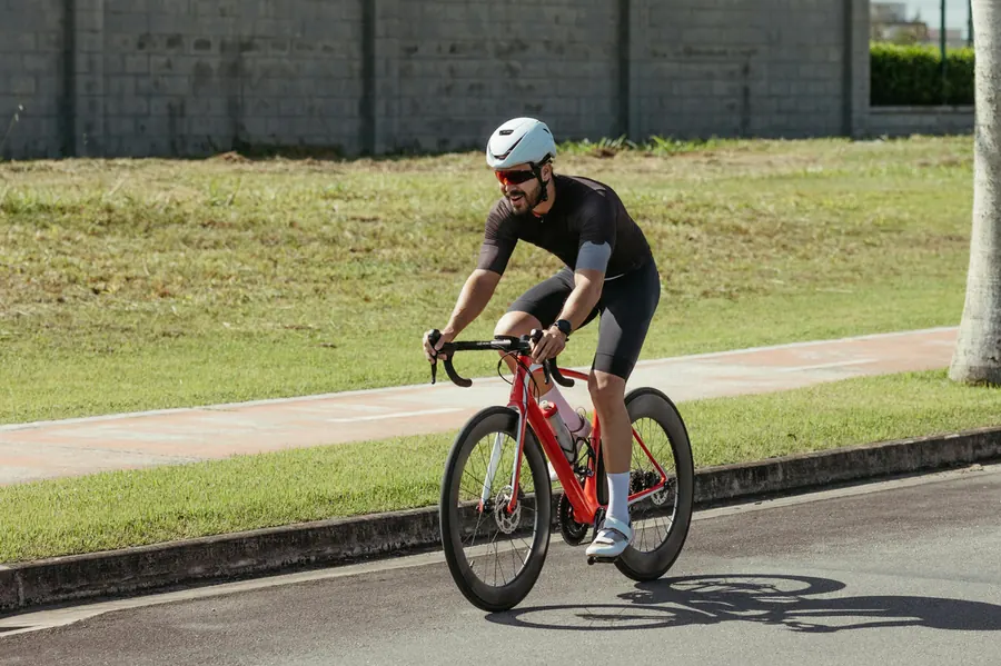 Man cycling on a road bike outdoors on a sunny day