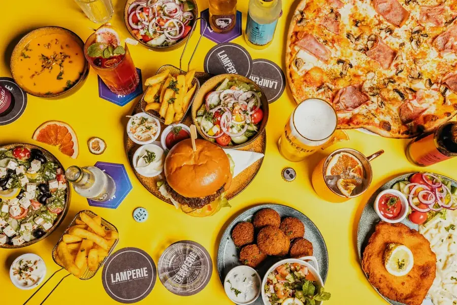 Overhead view of ultra-processed foods including burgers, fries, and pizza