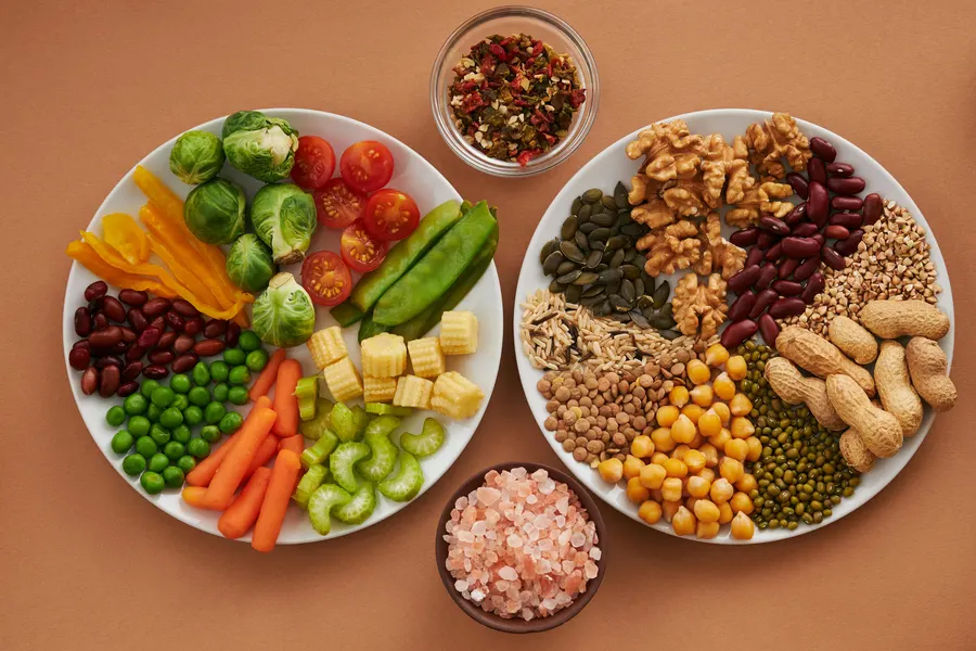 High fiber foods including legumes, whole grains, vegetables and fruits arranged together