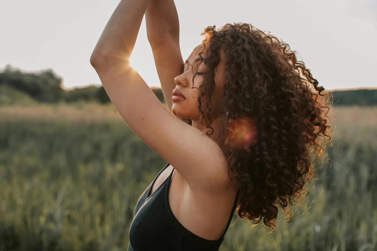 Woman in sunlight outdoors with golden hour light